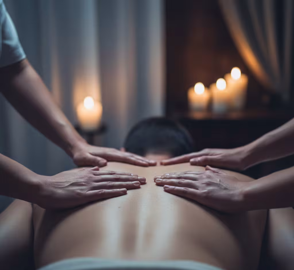 Close‑up of synchronized therapist hands during four hands massage at Queens Club Nirvana Spa Islamabad.