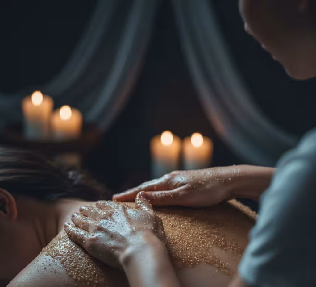 Close‑up of therapist applying scrub during full body treatment at Queens Club Nirvana Spa Islamabad.
